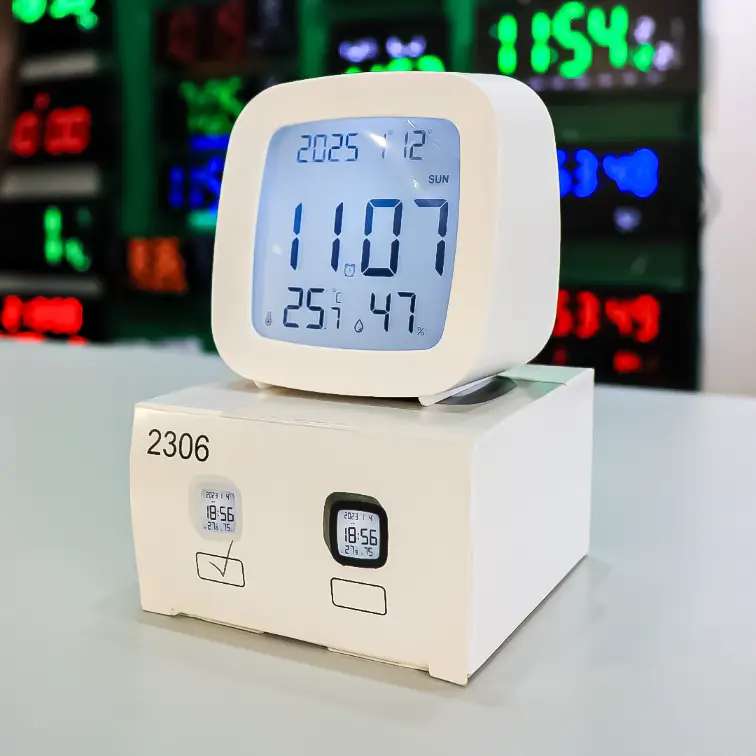 small desktop white LCD Digital clock displaying temperature, humidity and time
