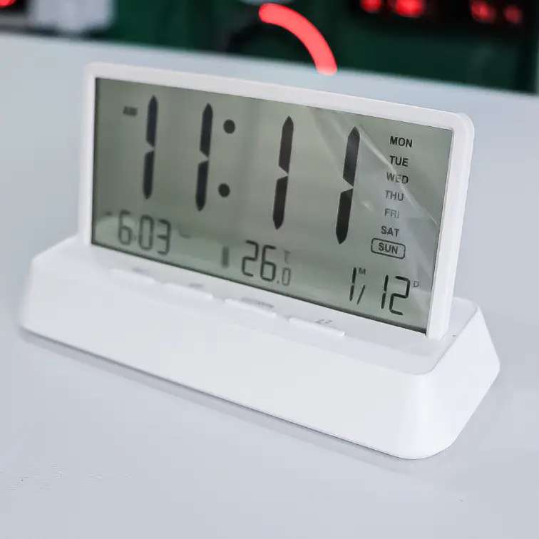 white LCD desktop clock with large digits